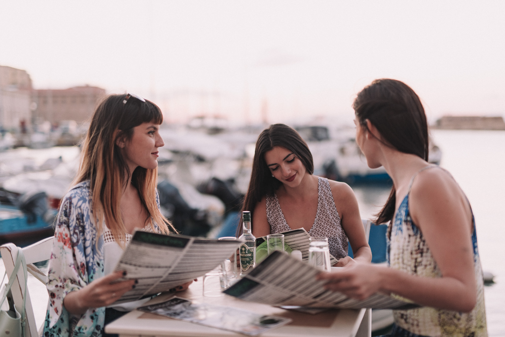 Girls having dinner in the Venetian Harbor of Chania Crete